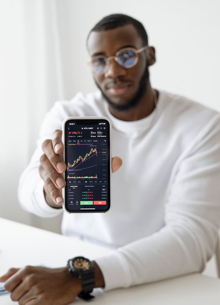 digital-01 Businessman showing stock graph on smartphone, symbolizing market trends.