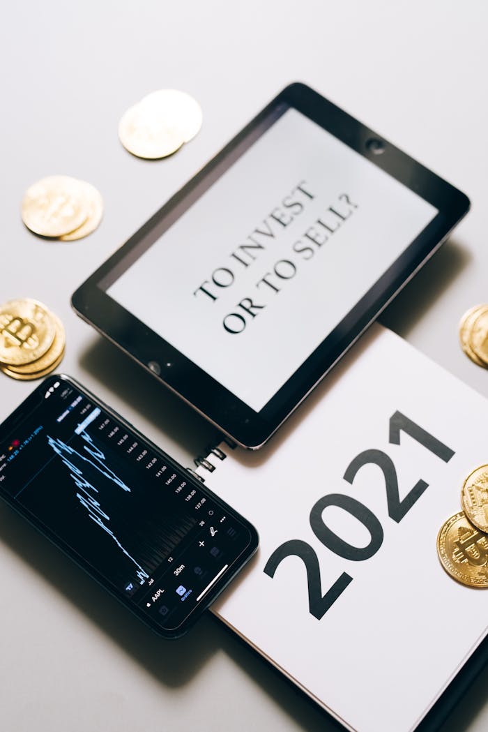 creative-02 Tablet with investment question amidst bitcoins and 2021 planner. Analyze crypto trends.
